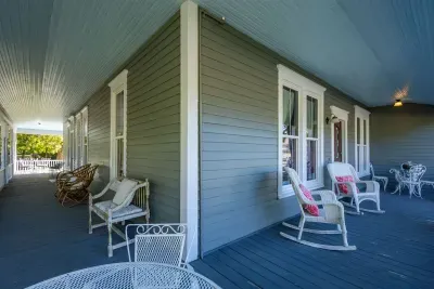 The wrap-around porch is perfect for relaxing while enjoying the fresh air and surrounding views. With ample seating and a peaceful setting, it’s an ideal spot for morning coffee, reading, or socializing with family and friends.