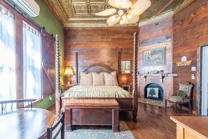 Spacious and elegant room featuring a California king bed, 12-foot ceilings, and stunning original shiplap accents