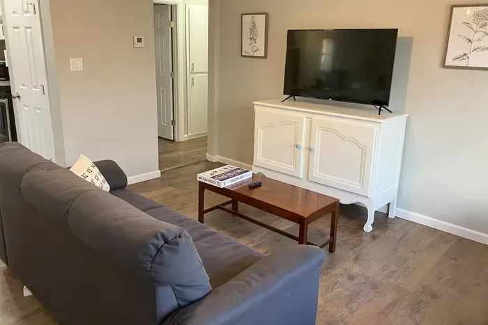 Another angle of the cozy living room with streaming capabilities and plenty of seating for your group