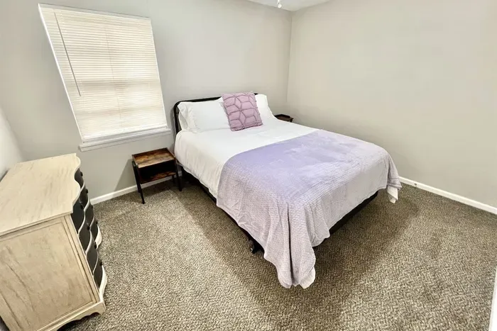 Third bedroom with soft, high-quality linens and modern decor, designed for a restful night’s sleep
