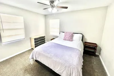 Another view of the third bedroom showcasing its cozy atmosphere and ample space for comfort