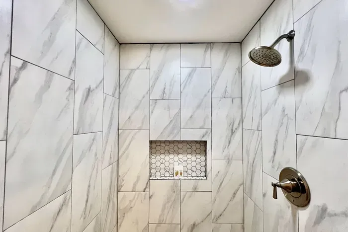 Newly remodeled bathroom with a huge walk-in shower, offering a spa-like experience during your stay