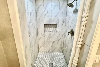 Elegant walk-in shower with stylish tile work, located in the master bathroom for added luxury