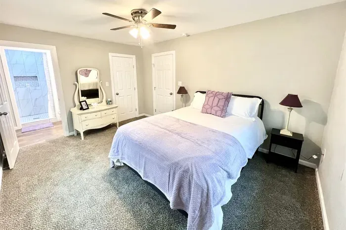 Spacious master bedroom featuring a queen bed with brand-new luxury linens and plenty of natural light for a peaceful night’s sleep