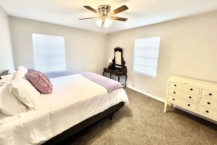 Third bedroom with a queen bed and updated decor, offering a cozy and inviting space for guests
