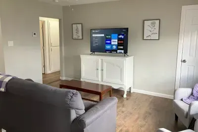 Open living room with a smart TV and comfortable seating, ideal for streaming your favorite shows after a day in Stephenville