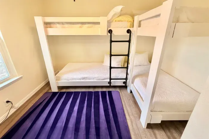 Third bedroom featuring two bunk beds (sleeps 4) — perfect for kids or group stays.