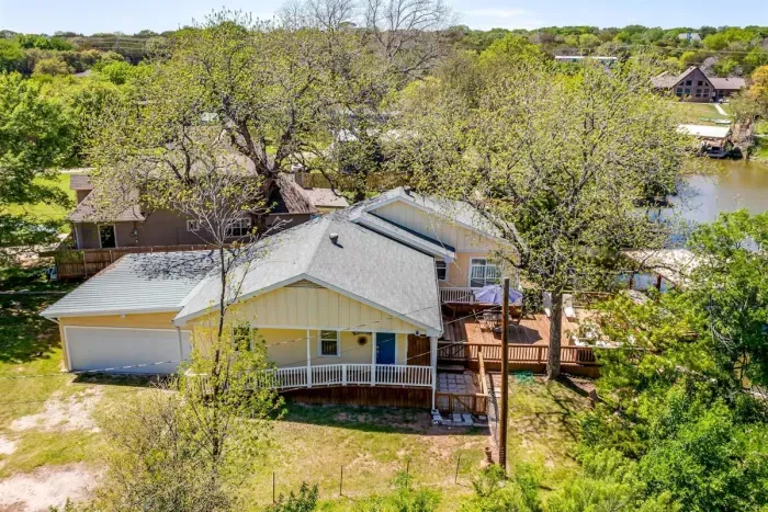 Charming lakefront exterior nestled in a quiet Granbury neighborhood.