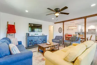 Bright open-concept living room with ample seating, large Smart TV, and comfortable space for gathering after a day on the lake.