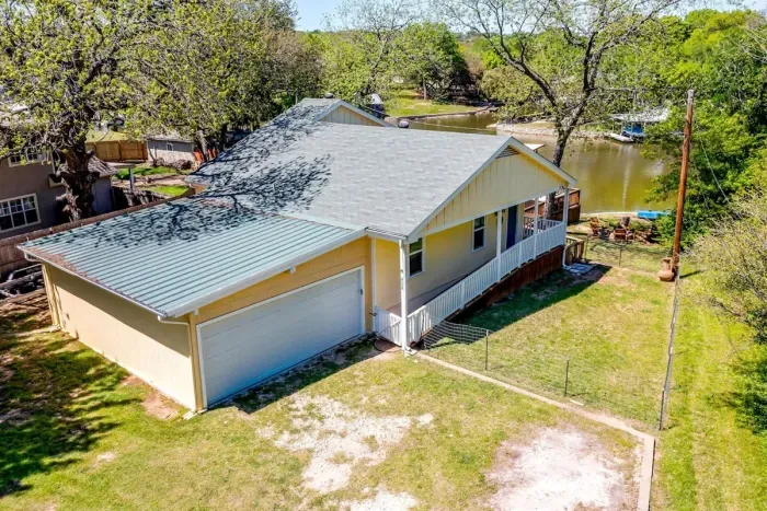 Exterior view of lakefront home with ample parking and convenient access to the property.