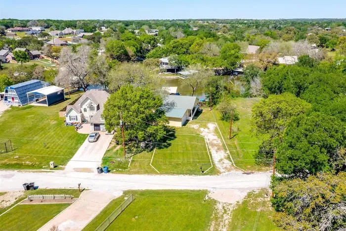 Aerial view of private driveway and canal-front location — easy access and peaceful waterfront setting.