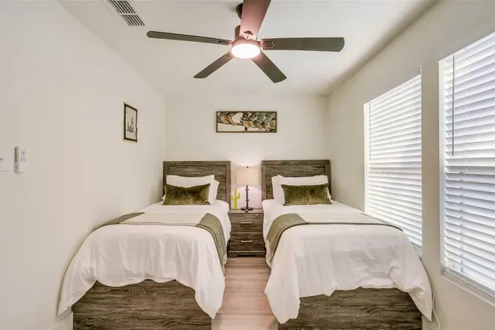 Thoughtfully designed twin bedroom with Smart TV and blackout blinds for restful sleep — ideal for families or group getaways.