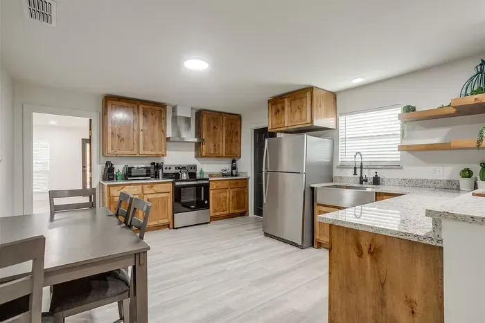 Brand new modern appliances and rustic cabinetry blend comfort and style in this chef-ready space.