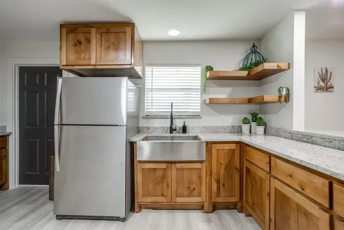 Stainless steel fridge and spacious counters make meal prep a breeze.
