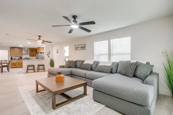 Enjoy a large sectional sofa in a bright, airy living space — perfect for movie nights or game day with Smart TV included.