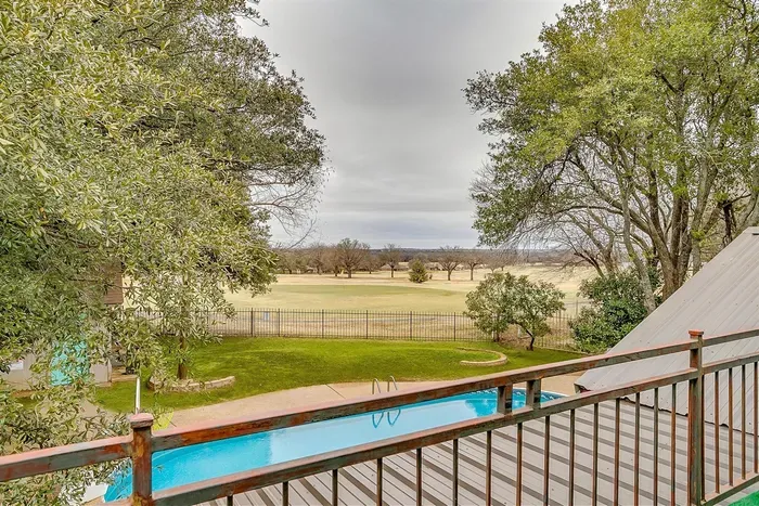 Enjoy your morning coffee or evening drinks on the private balcony off the master bedroom, offering panoramic views of the pool and the golf course