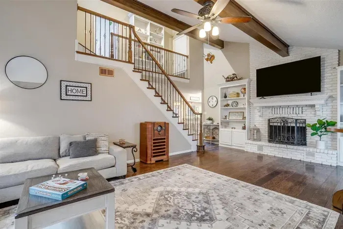 Spacious living room with a comfortable sectional couch, smart TV, and elegant decor, making it the perfect place for family gatherings or movie nights