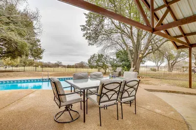 Relax in the shade on the covered patio with comfortable seating, offering a peaceful retreat with views of the pool and golf course