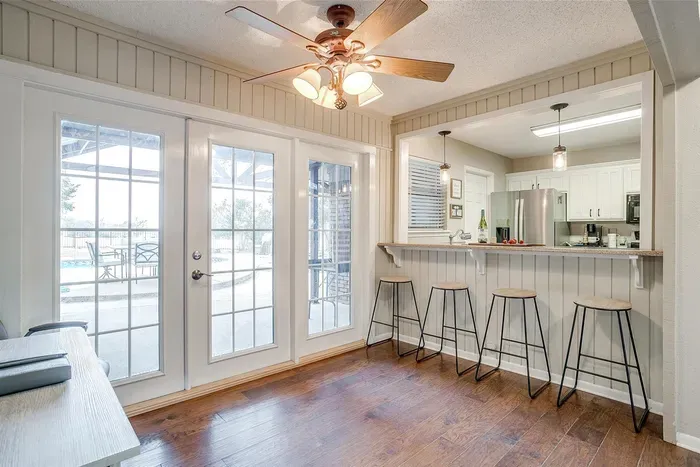 Inviting kitchen area with a stylish bar top and seating, ideal for enjoying breakfast or keeping the chef company while meals are prepared