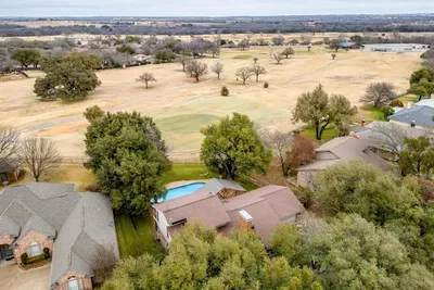 Breathtaking aerial shot of the property, highlighting its prime location on the golf course with beautiful natural surroundings