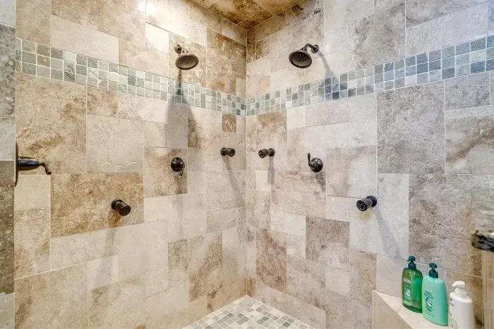 Indulge in the spa-like master ensuite bathroom featuring a double luxury shower with premium fixtures for ultimate relaxation