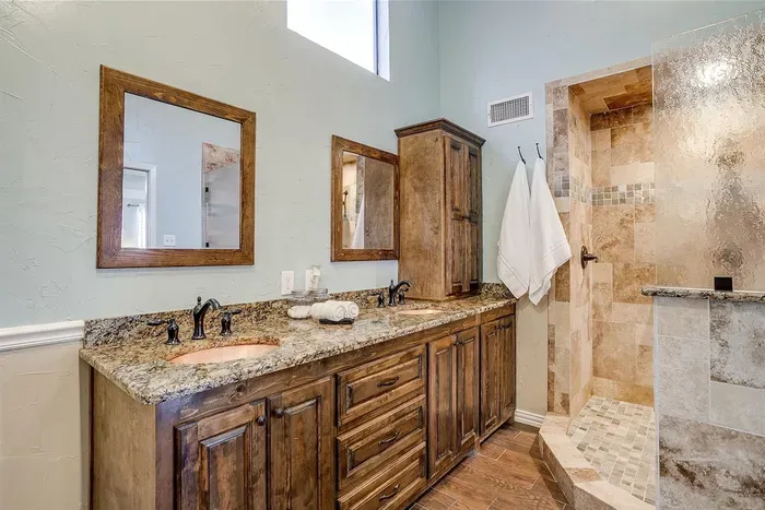 Luxurious bathroom featuring a spacious walk-in shower with high-end fixtures and plenty of natural light for a refreshing start to your day
