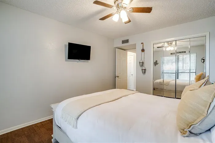 Spacious guest room featuring a queen-size bed, warm decor, and natural light to create a relaxing retreat for guests