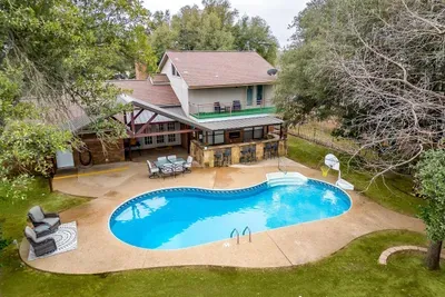 Stunning aerial view showcasing the private pool, spacious patio, and lush surroundings, providing a perfect blend of relaxation and entertainment