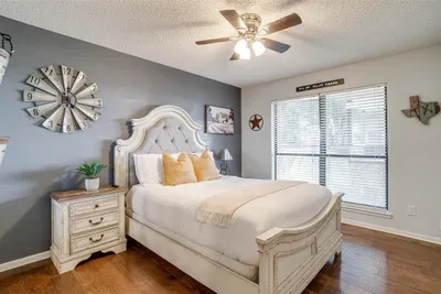 Cozy queen-size bed in a serene bedroom setting, complete with soft linens, stylish furnishings, and a smart TV for added convenience