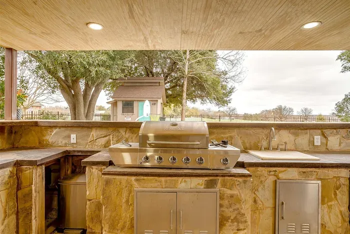 Grill up your favorite meals on this large gas BBQ grill, located in the outdoor kitchen for a seamless cooking experience