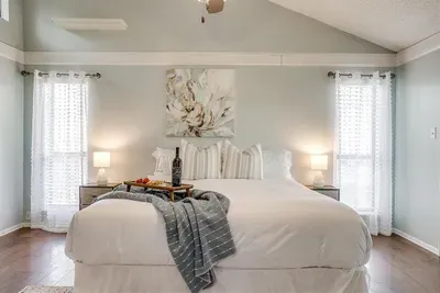Master bedroom with a king-size bed, soft linens, smart TV, and ensuite bathroom with a double luxury shower for a tranquil retreat