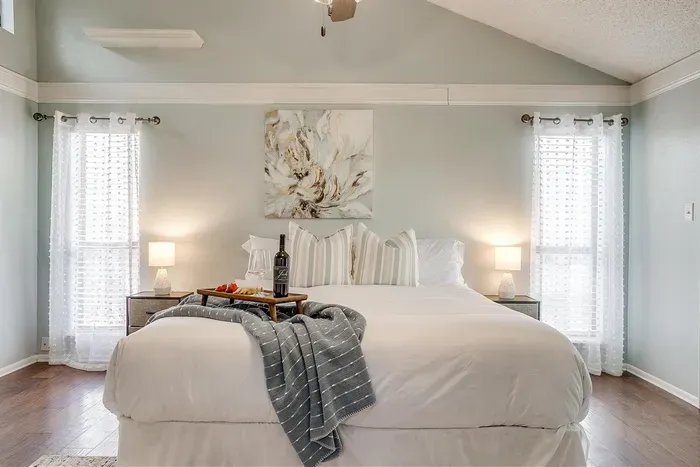 Master bedroom with a king-size bed, soft linens, smart TV, and ensuite bathroom with a double luxury shower for a tranquil retreat