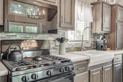 Gas range and farmhouse sink ready for home cooking