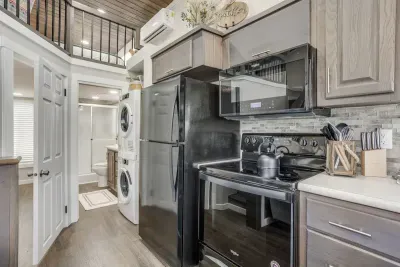 Open kitchen with a loft above and laundry tucked in