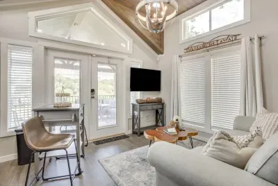 Airy living room with vaulted ceilings and porch doors