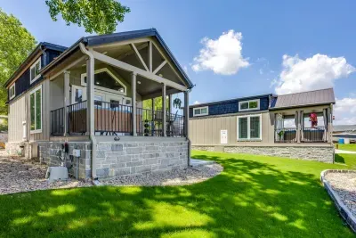 Two craftsman cabins with covered porches on the green lawn