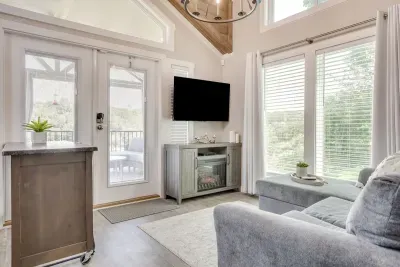Bright living room with a fireplace and lake-view doors