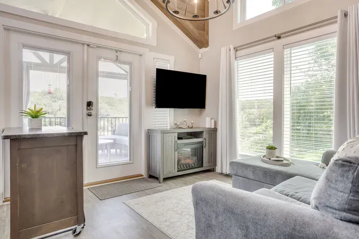 Bright living room with a fireplace and lake-view doors
