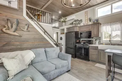 Open living and kitchen beneath a lofted bedroom retreat