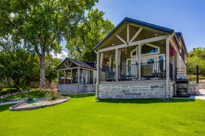 Craftsman cabin with a covered porch and big shady yard