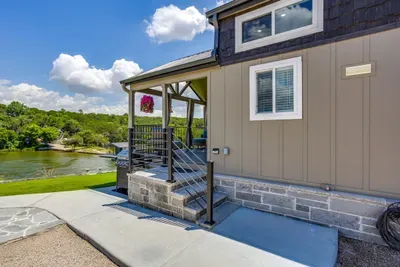 Tiny-home porch overlooking the water just beyond