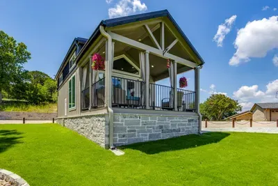 Inviting covered porch framed by a manicured green lawn