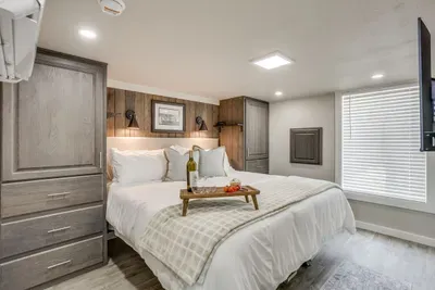 Serene king bedroom wrapped in warm wood accents