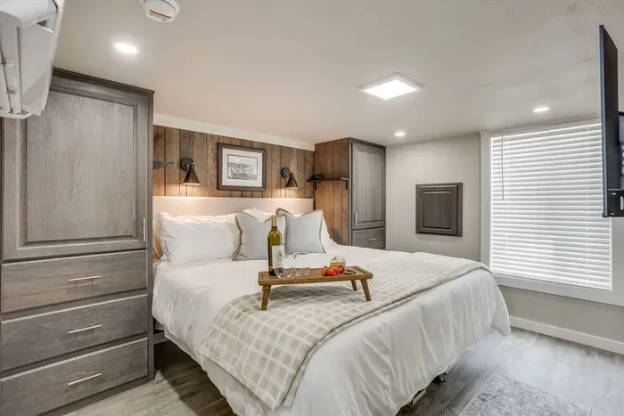 Serene king bedroom wrapped in warm wood accents