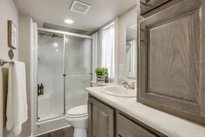 Clean walk-in shower and vanity in the full bathroom