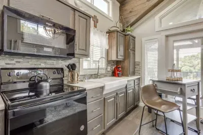 Full kitchen with a farmhouse sink and breakfast bar and all the pots / pans you'll need