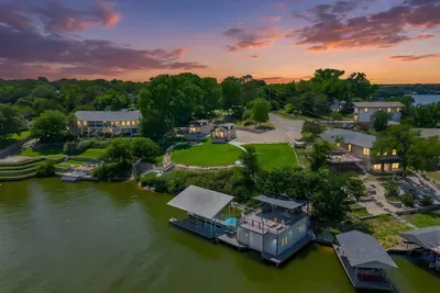 Sunset aerial over the lakefront retreat and two-tier dock