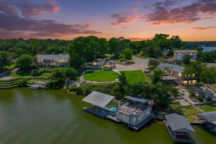 Sunset aerial over the lakefront retreat and two-tier dock