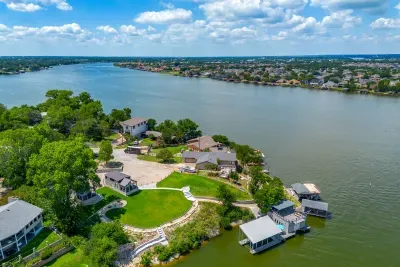 A private grassy point with a dock on the lake