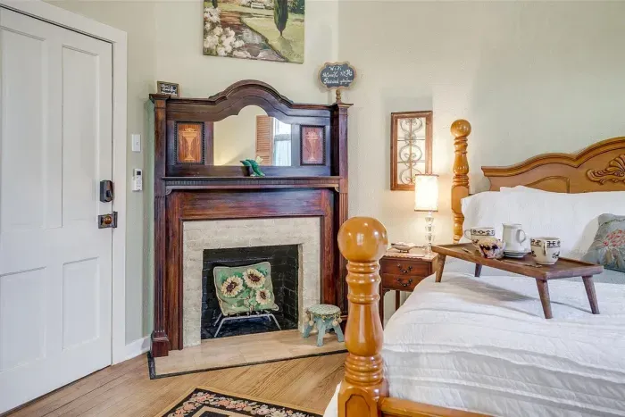 Charming original fireplace in Kason's Cove adds warmth and character to this beautiful space